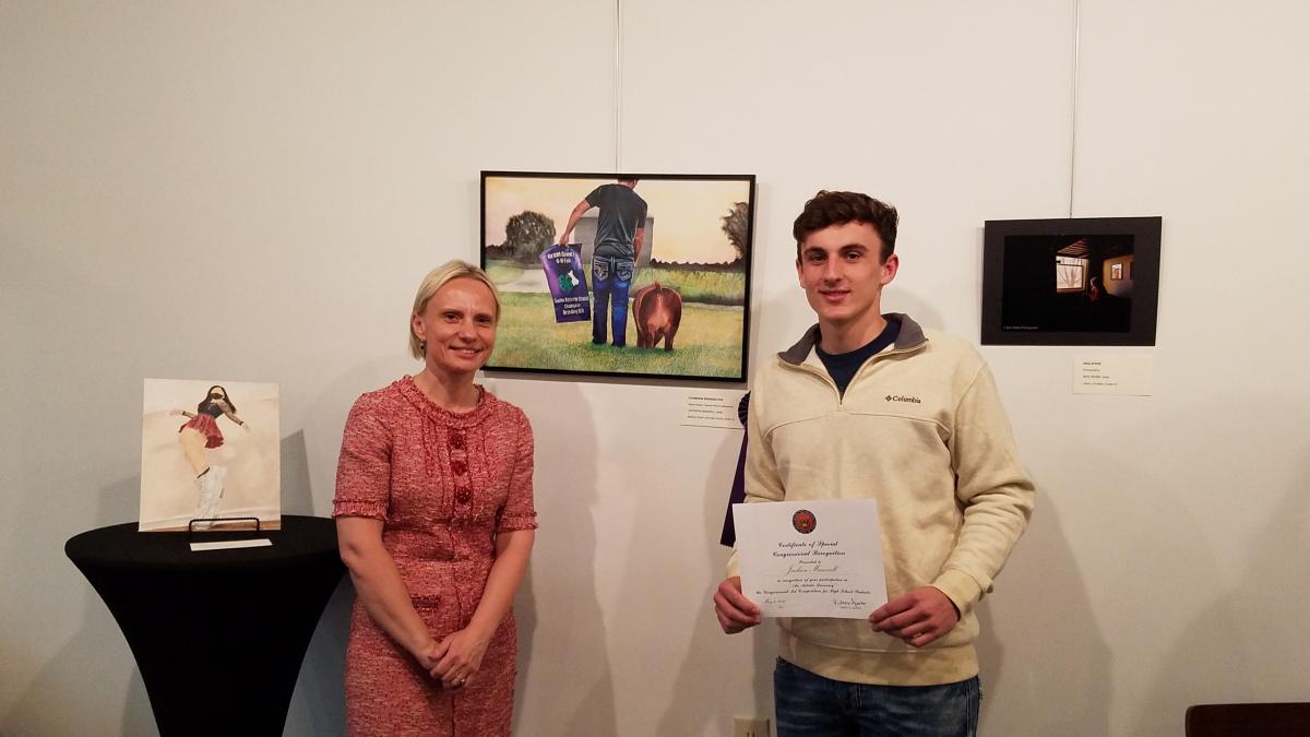 Rep. Spartz poses with the winner of the 2021 Congressional Art Competition