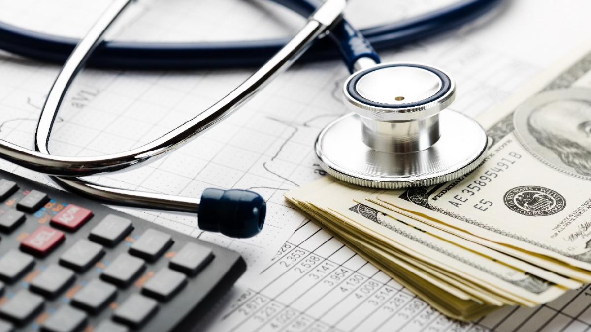 Medical devices juxtaposed with a stack of dollar bills