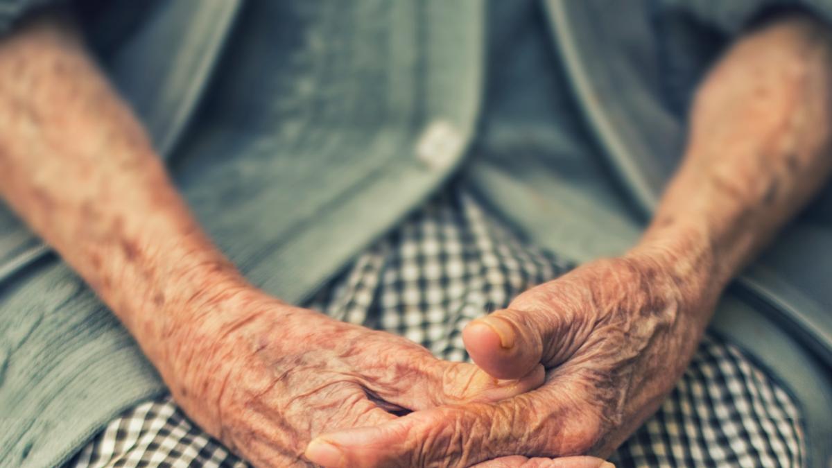 close up of elderly woman's hands on lap