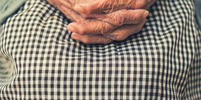 close up of elderly woman's hands on lap
