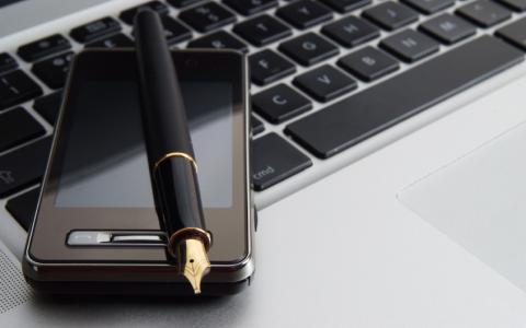 Photo of keyboard, mobile phone and pen